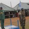 A Ugandan soldier salutes in front of a UNMISS field hospital tent during a UNAMID mission in Sudan.
