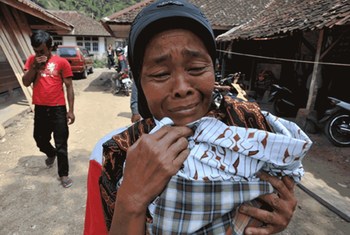 A survivor outside her home in West Java Province, Indonesia, following the powerful quake on on 2 September 2009.