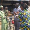 The 50,000th returnee, a baby girl called Happiness, with her parents and relatives