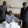 AU Special Representative NicolasBwakira (left) and Burundi's Ambassador toKenya (right) with an injured peacekeeperat a Nairobi Hospital