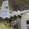 UN peacekeeper inspects wreckage of MINUSTAH plane that slammed into a mountain (AP Photo/Diev Nalio Chery)