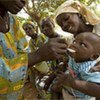 A woman gives a toddler a spoonful of oral rehydration salts to treat diarrhoeal dehydration.