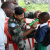 Civilian eye specialist, Dr. Kabuyaya (left) and Lt Col K Shyamsundar, Cl Spl (Ophthalmology) , examine a child at the Himbi Primary School in Goma