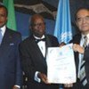 Jean Serge Essous (centre), UNESCO Artist for Peace, during the designation ceremony on 11 October 2006
