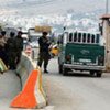 Israeli soldiers inspect Palestinians' documents at the Hawera checkpoint outside Nablus town in the West Bank