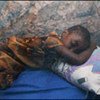 A child sleeps under a malaria bednet