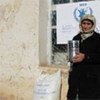 Rajabgul Rasulova, 42, with the food rations that will enable her to celebrate New Year