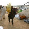 A displaced man from South Waziristan collects a package of aid from UNHCR
