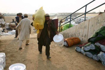 A displaced man from South Waziristan collects a package of aid from UNHCR