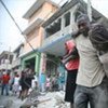 A survivor is pulled out of the rubble following the deadly Haiti earthquake