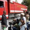 Haitians receive water from firefighters