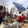 A group of IDPs outside their crude shelters in an area west of Mogadishu