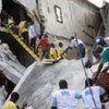 Haitian workers clear out damaged warehouse in Port-au-Prince