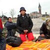 A young Afghan boy and friends gather in a field near the City Hall in Calais, France