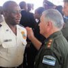 UN Police Commissioner Gerardo Chaumont consoles Haitian National Police (HNP) officer