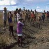 Farmers dig canals that will be used to irrigate their land once a dam is complete in Tsivory, Madagascar