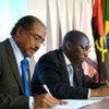 UNAIDS head Michel Sidibé (left) and CPLP's Domingos Simões Pereira sign agreement