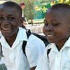 Fraternal twins Jean-Rene and Jean-Raymond Michel, 13, are all smiles after their first day back to school.