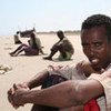 An exhausted survivor of the dangerous sea crossing to Yemen from the Horn of Africa