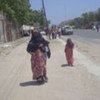A Somali woman and her children in Mogadishu making their way to safety