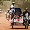 Seybatu Koroma rides a UNICEF-supported motorcycle ambulance  to a hospital in Bonthe, Sierra Leone