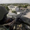 A peacekeeper at an African Union-controlled post overlooking a section of Mogadishu