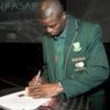 Captain of the South Africa football team Aaron Mokoena signing the UNAIDS World Cup Appeal