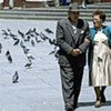 An elderly couple walks arm-in-arm in Bolivia