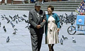 An elderly couple walks arm-in-arm in Bolivia