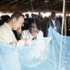 Secretary-General Ban Ki-moon  inspects a mosquito net at Mwandama Millennium Village, Malawi in May 2010