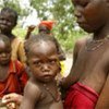 A young mother with daughter after fleeing into the bush when armed groups attacked her village of Boutouli