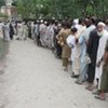 Flood victims line up at a food distribution point in Northwestern Pakistan
