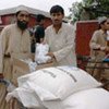 Flood victims collect one-month rations at distribution point in  hard-hit Peshawar district