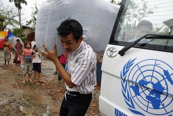 UN aid worker distributes blankets to survivors displaced by cyclone Nargis, Myanmar