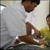 Doctor checks woman's blood pressure in a rural health care clinic, Lao People's Democratic Republic