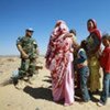 A MINURSO officer chats with a group of local Western Saharans