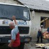 Displaced Roma carry belongings towards a UNHCR truck at Cesmin Lug in Kosovo