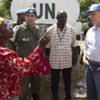 Head of UN Mission in Haiti Edmond Mulet (right) speaks with a resident at a camp for displaced people in Jacmel