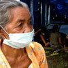 An elderly woman awaits assistance at an evacuation centre for those displaced by the Mount Merapi volcano in Indonesia