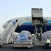 Tents destined for victims of flooding are unloaded from a UN-chartered cargo plane in Cotonou