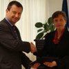 UK Ambassador Paul Arkwright (left) presents donation to the Registrar of the ICC Silvana Arbia