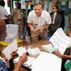 An observer speaks with staff of a polling station during voting in Côte d’Ivoire’s run-off elections on 28 November 2010