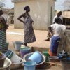 Women who fled their villages collect water in Guiglo, western Côte d’Ivoire