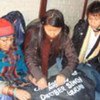 Devi Maya (left), the 40,000th refugee originating from Bhutan to be resettled from Nepal, does some last minute packing