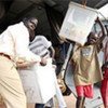 Residents of the road-less Tali region of Central Equatoria State unloading voting materials from UNMIS helicopter