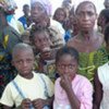 Newly-arrived Ivorian women and children refugees await registration in Luguato, Liberia