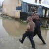 A couple of boys walking through the floodwaters in the Vruja settlement in Montenegro