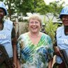 Executive Director of UN Women Michelle Bachelet is flanked by female peacekeepers in Liberia