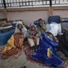 A group of Sudanese huddles against the cold at the Saloum border post in Egypt after fleeing Libya
