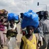 Ivoirians carry their belongings as they escape the fighting